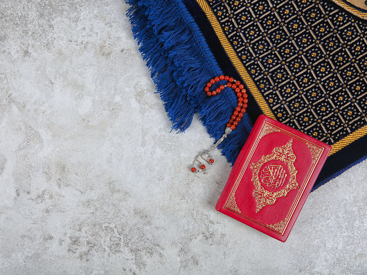 Muslim Prayer Beads, Quran, Rug And Space For Text On Grey Backg